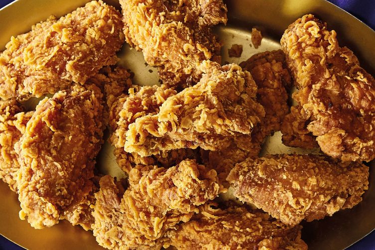 Crispy chicken wings sit in a bowl.